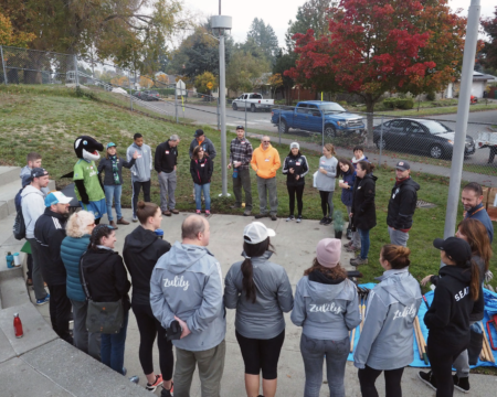 A group of volunteers stand in a circle.