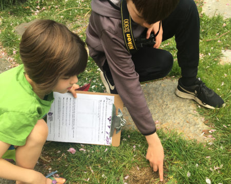 2 siblings use the Nature Scavenger Hunt activity to explore the nature in their backyard.