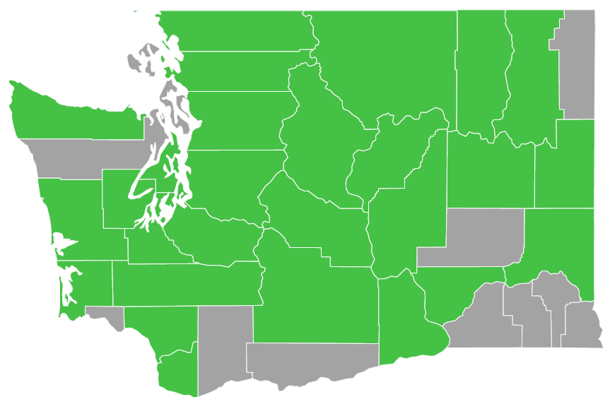 Map of Washington state with county outlines. There are 27 counties filled in green to represent the counties where Washington Green Schools provided service. The other 12 counties are grey.