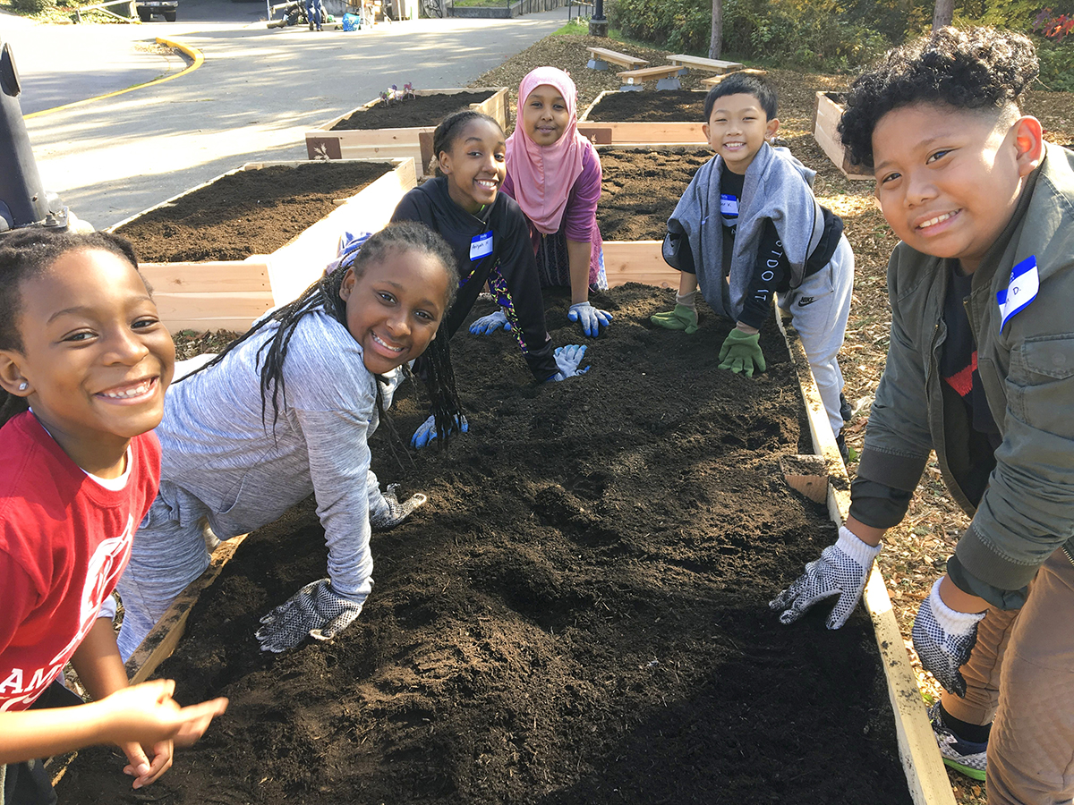 6 students stand next to a newly built raised bed