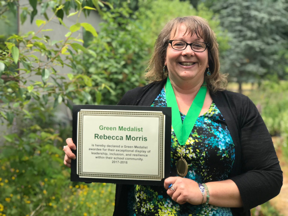 Rebecca Morris poses with her green medal and her Green Medalist certificate