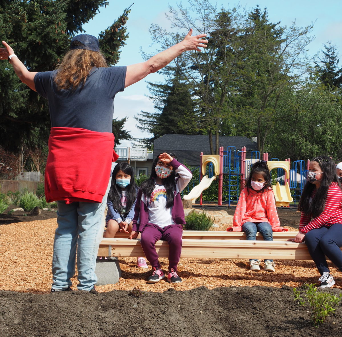 Students at Hilltop Elementary test out the benches in their new outdoor classroom.