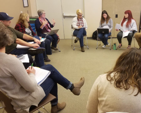 Educators sit in a circle during a meeting of the Climate Justice League