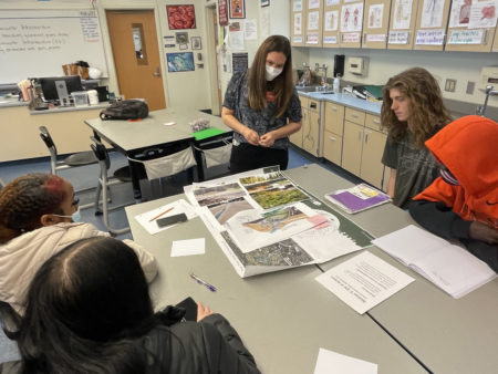 Students meet with a landscape architect to plan and build the rain garden on their campus.