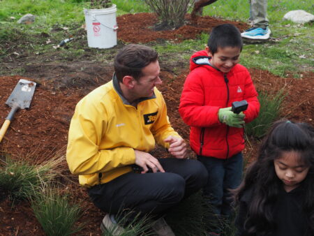 Chris Cashman, a King 5 News reporter interacts with a student holding a GoPro camera