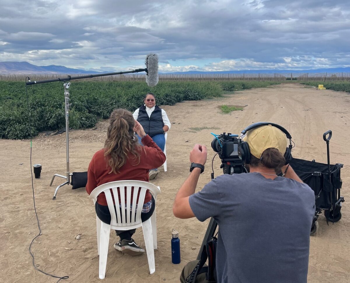 Jonalee Squeochs, an environmental scientist and program manager at Yakama Nation Agricultural Development sits in front of a camera crew to share her career journey.
