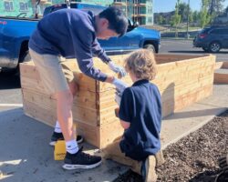 Students at Spokane International Academy partner with EarthGen to bring nature back to their campus, starting with student-built raised garden beds