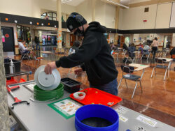 A high school student in Clark County takes part in sorting lunchroom waste.