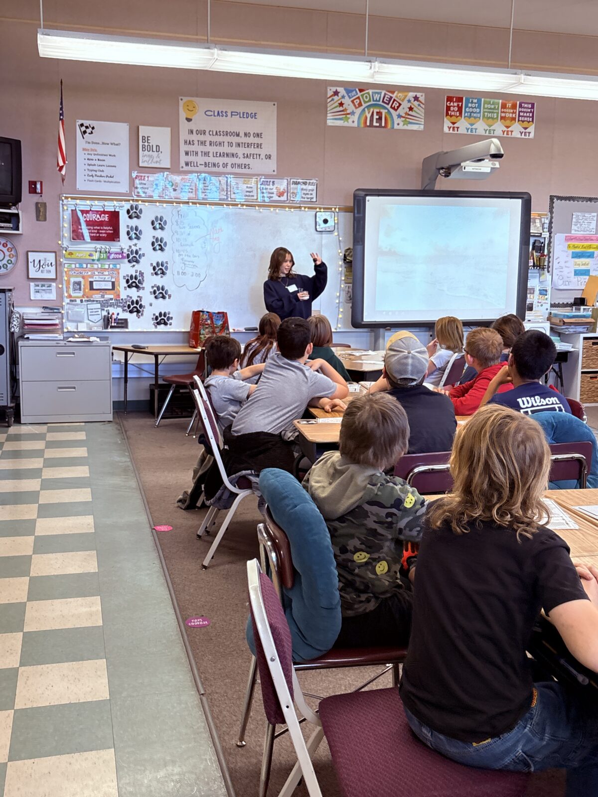 Lilly stands up in the front of a fifth grade classroom teaching students about extreme hear.