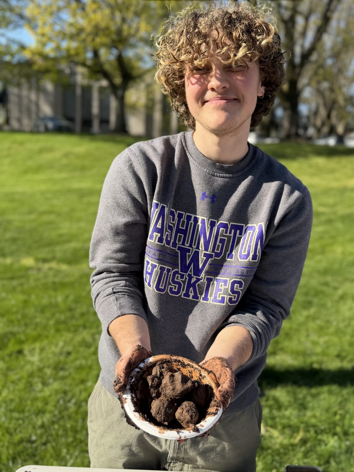 Lucas holds up a plate full of freshly made seed balls